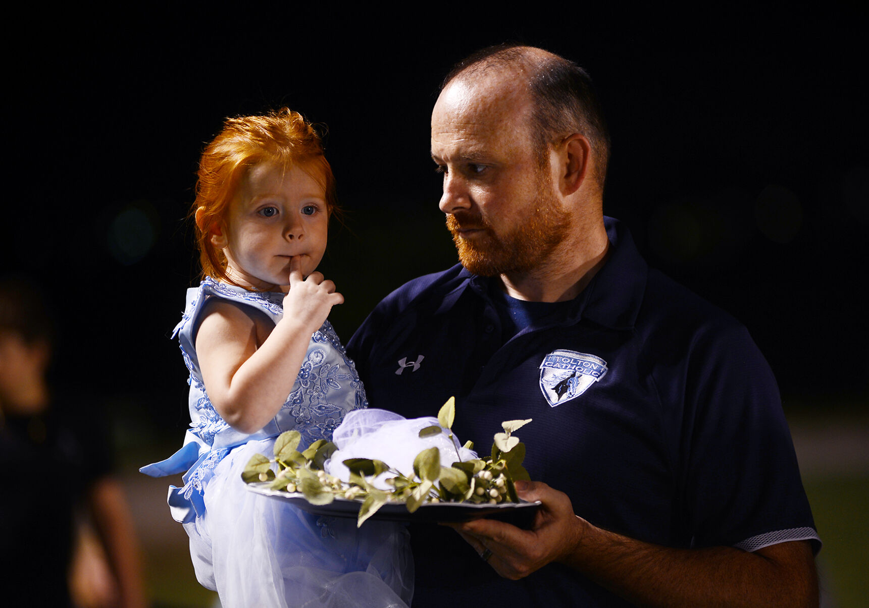 Matt Rose and his daughter Cora Rose wait before the homecoming